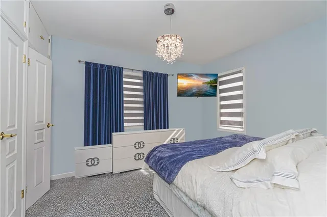 a bedroom with two beds and a window