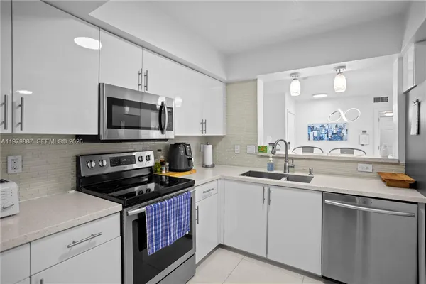 a kitchen with a sink and appliances