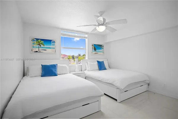 a bedroom with double bed and a chandelier