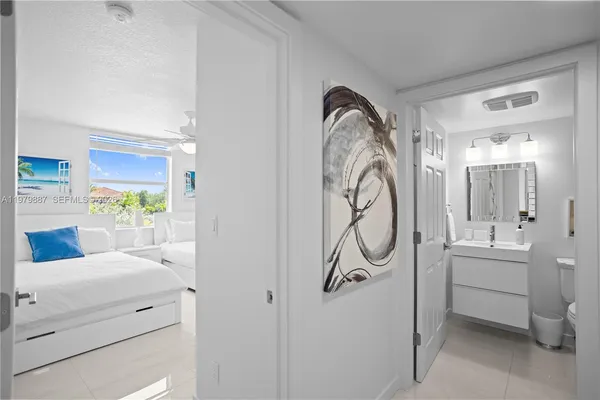 a en suite bathroom with a granite countertop sink and a mirror