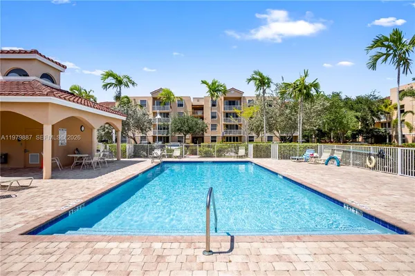 a view of a swimming pool with outdoor seating