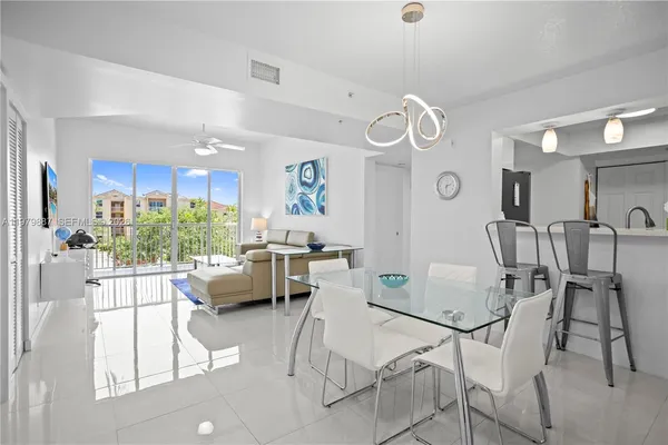 a view of a dining room with furniture and a large window