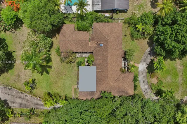 an aerial view of a house with a yard and garden