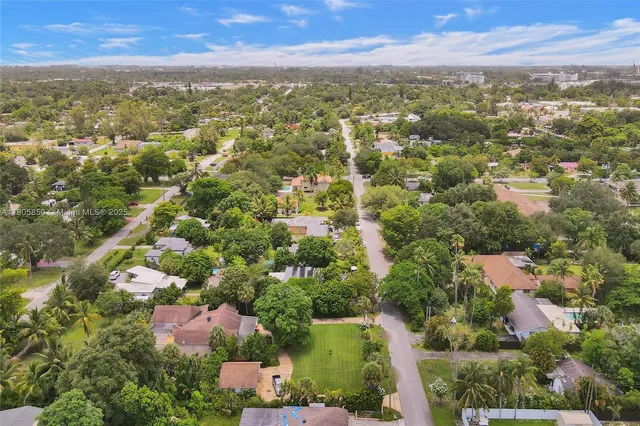 an aerial view of residential houses with city and outdoor space