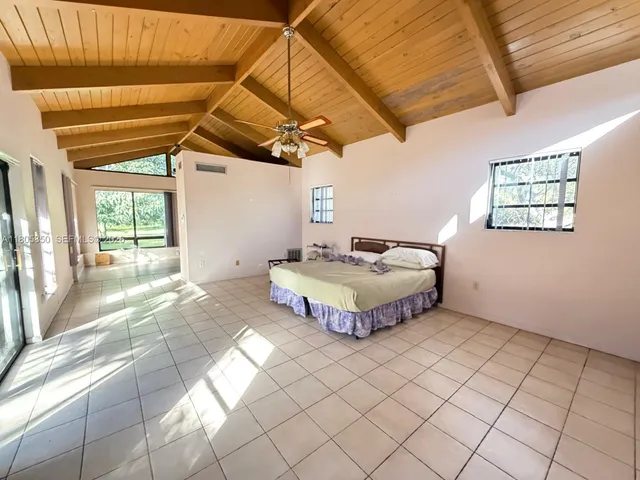 a spacious bedroom with a bed and window