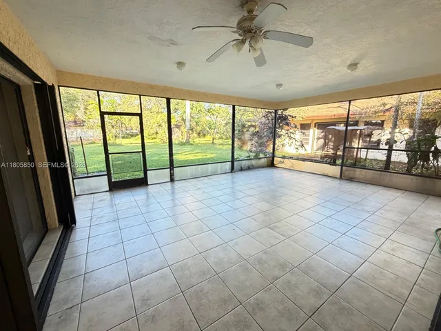 a view of a livingroom with a ceiling fan and window