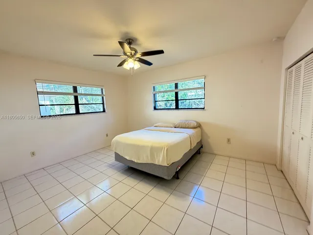 a spacious bedroom with a bed and a window