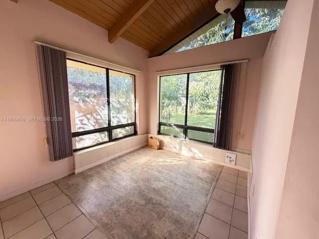 a view of an empty room with a fireplace and a large window