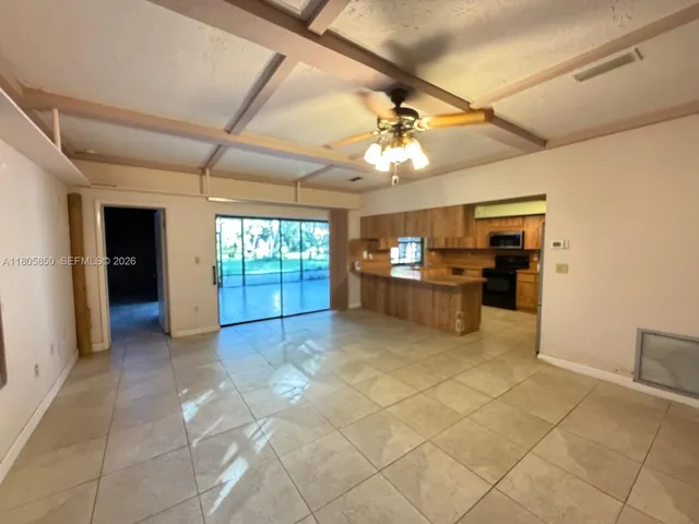 a view of a livingroom with furniture and chandelier fan