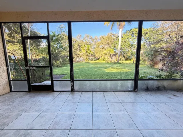 a view of a room with a large window and an outdoor view