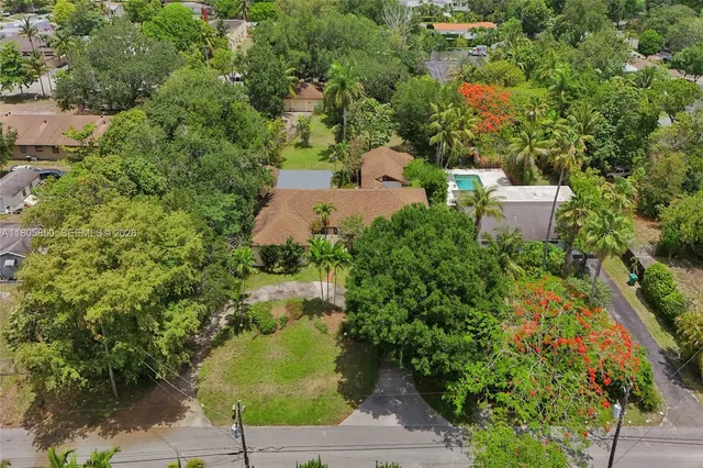 an aerial view of a house with a yard