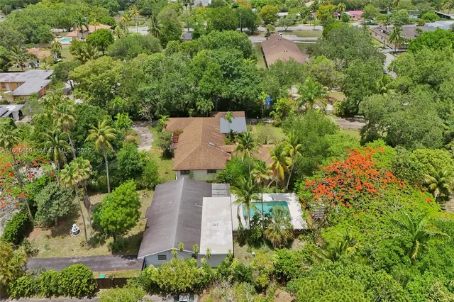 an aerial view of a house with a yard and lake view
