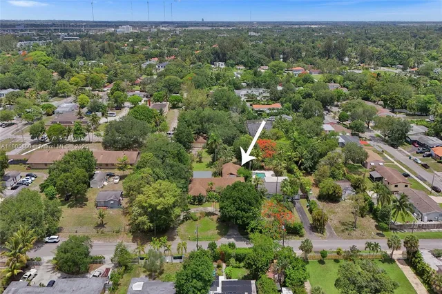 an aerial view of a houses with a yard