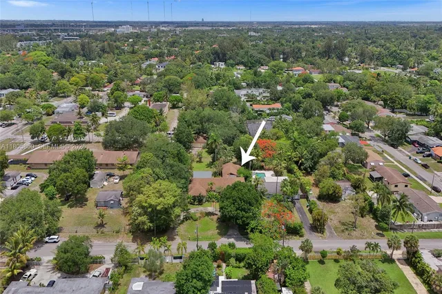 an aerial view of a houses with a yard