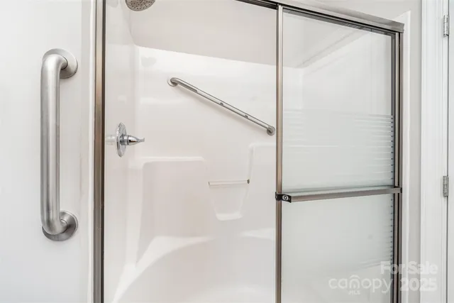 a bathroom with a glass shower door