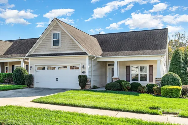 a view of a yard in front view of a house