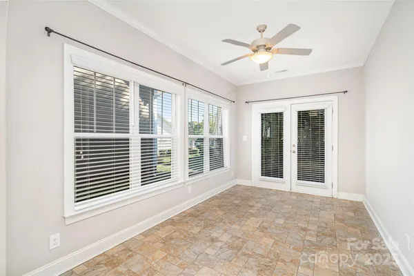 a view of a livingroom with a ceiling fan and window