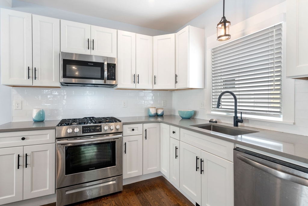 18 Harding Terrace Dedham, MA 02026 - Photo 2 of 38 a kitchen with white cabinets and appliances