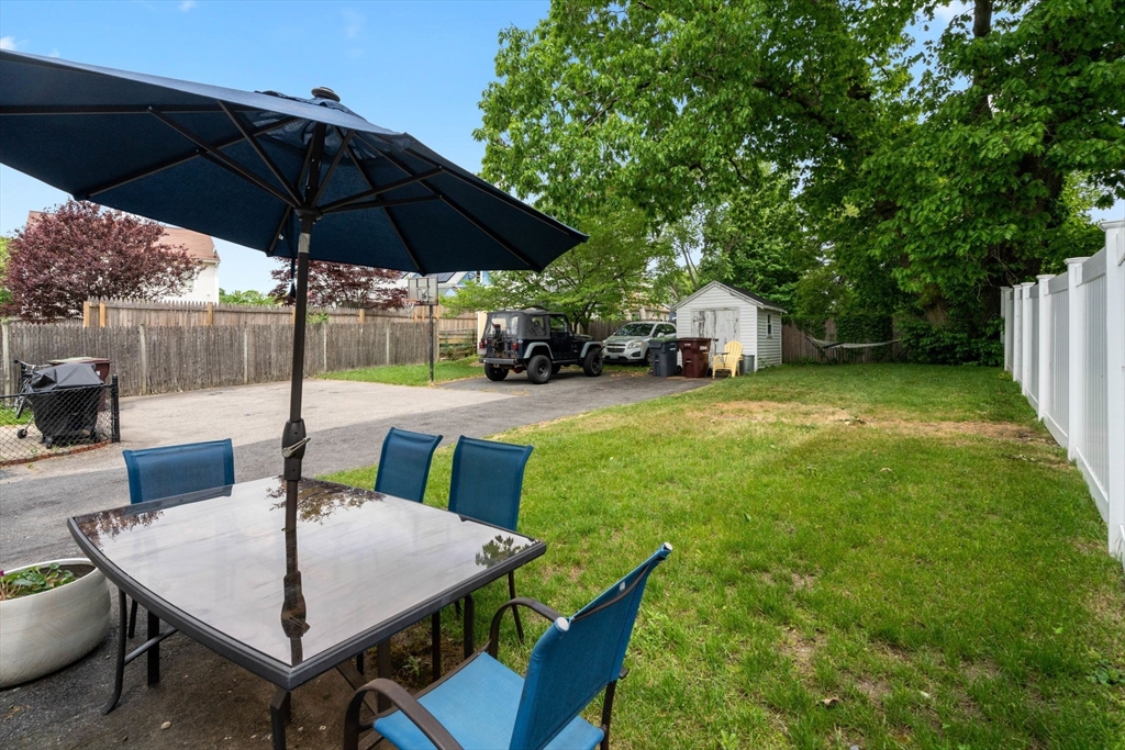 18 Harding Terrace Dedham, MA 02026 - Photo 28 of 38 a view of a patio with a table and chairs under an umbrella