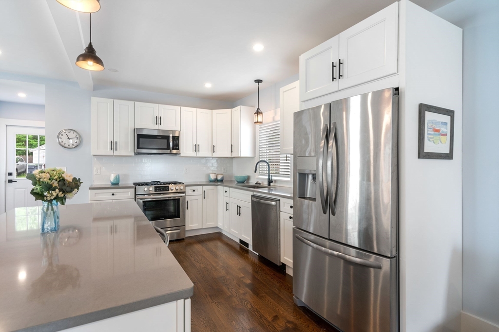 18 Harding Terrace Dedham, MA 02026 - Photo 3 of 38 a kitchen with kitchen island white cabinets a refrigerator a stove a sink and a refrigerator