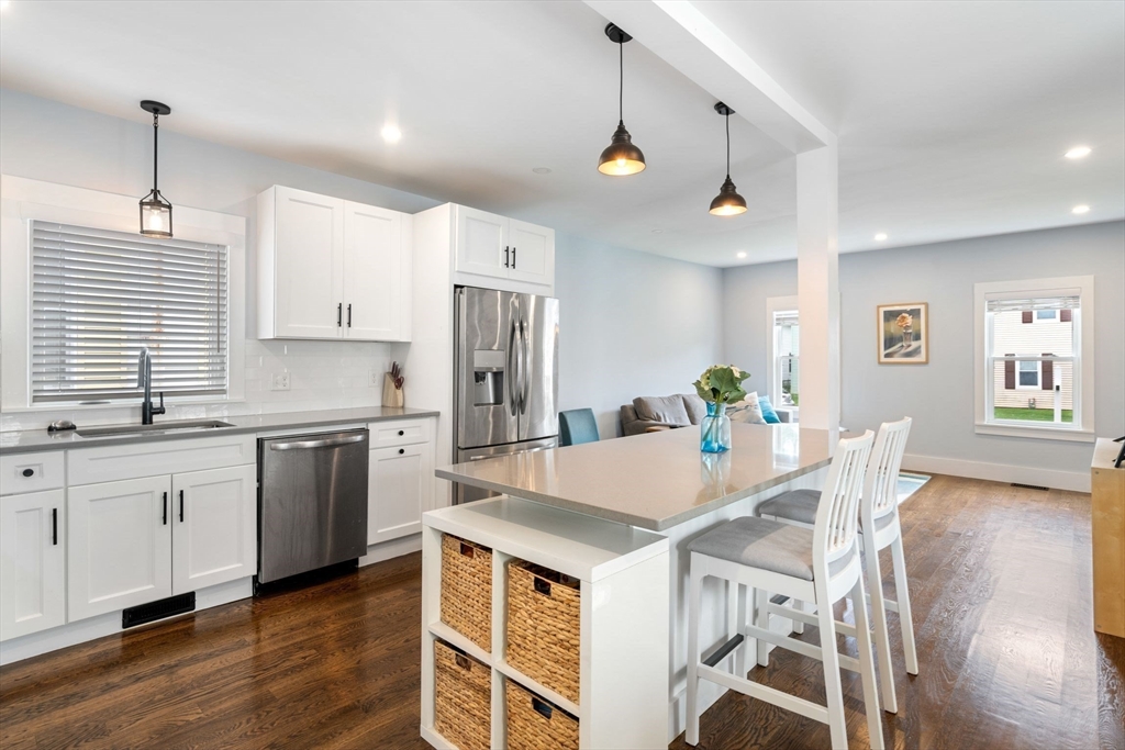 18 Harding Terrace Dedham, MA 02026 - Photo 4 of 38 a kitchen with stainless steel appliances kitchen island granite countertop a kitchen island hardwood floor and a sink