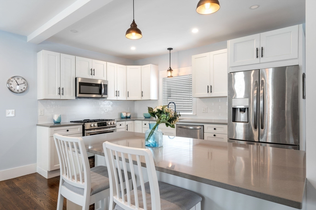 18 Harding Terrace Dedham, MA 02026 - Photo 6 of 38 a kitchen with stainless steel appliances granite countertop a refrigerator a stove top oven a sink and dishwasher