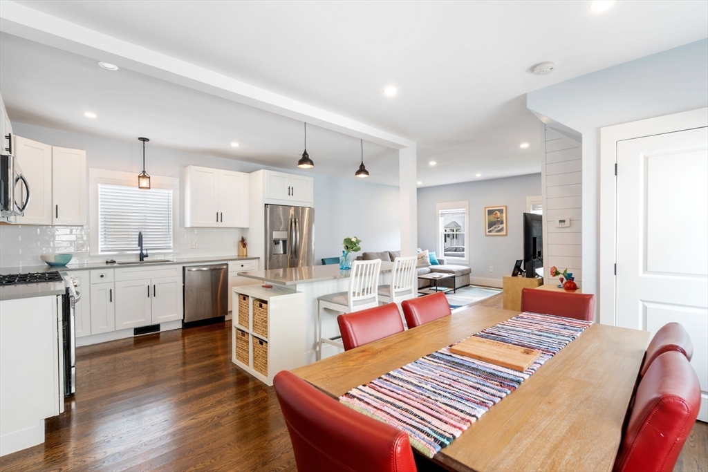 18 Harding Terrace Dedham, MA 02026 - Photo 7 of 38 a open kitchen with white cabinets and stainless steel appliances