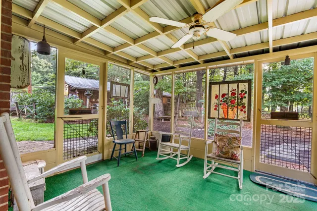 a view of a porch with furniture and a yard