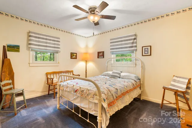 a bedroom with a bed a chair and a chandelier