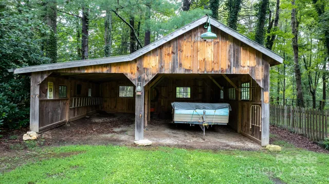 a view of a house with a yard chairs and a swing
