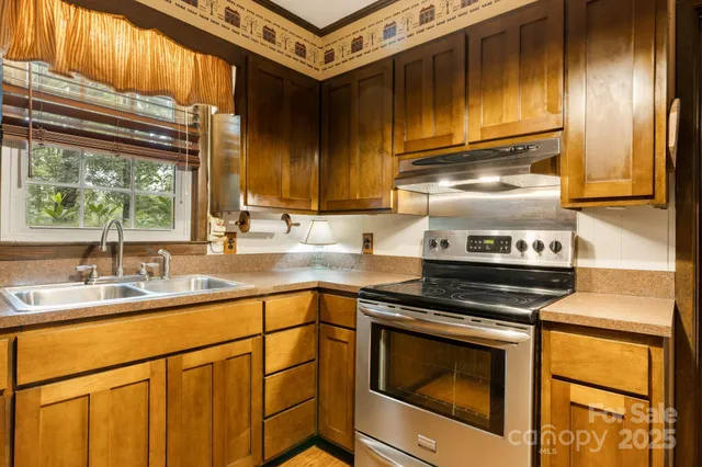 a kitchen with granite countertop cabinets stainless steel appliances and a sink