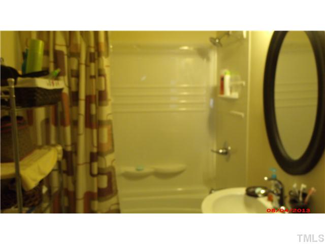 629 Coleman Street Raleigh, NC 27610 - Photo 11 of 25 a bathroom with a sink and a mirror