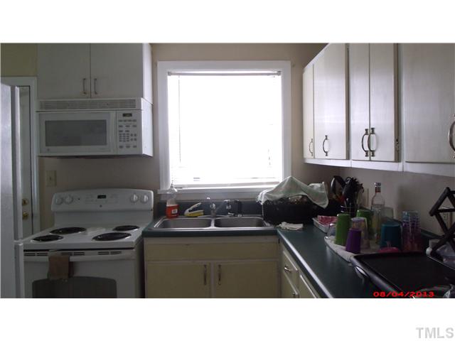629 Coleman Street Raleigh, NC 27610 - Photo 7 of 25 a kitchen with a window a sink and a cabinets