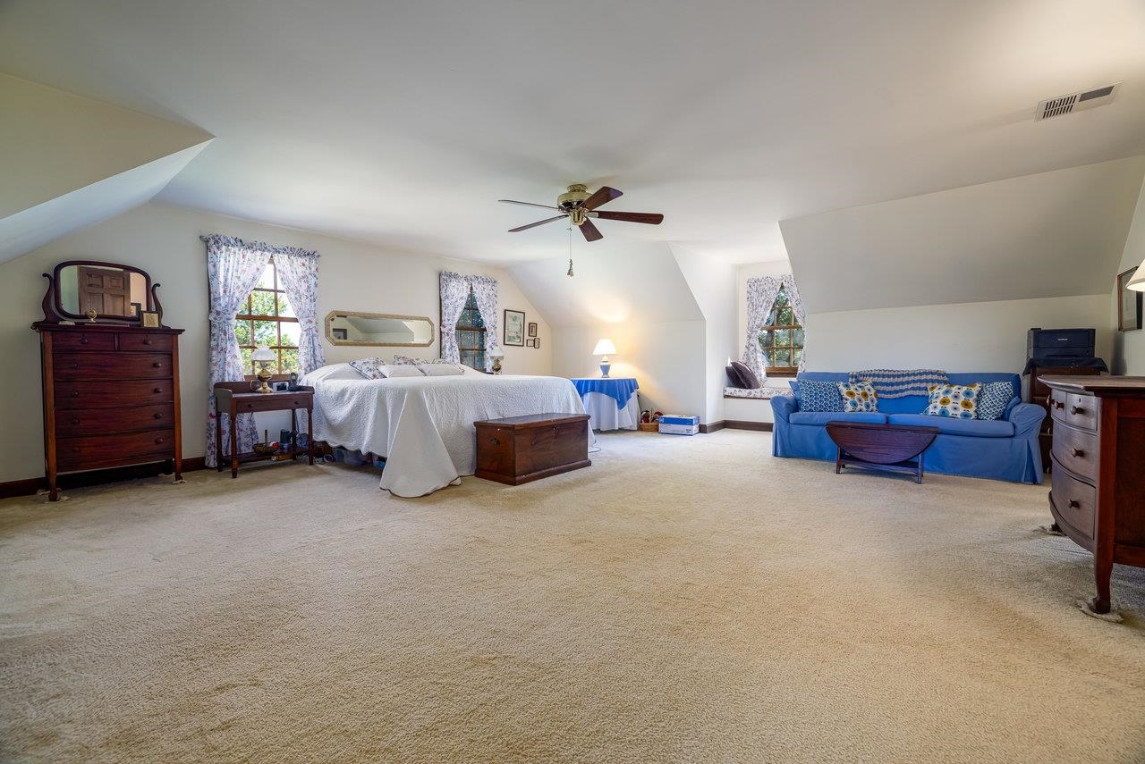 223 Fadley Road Weyers Cave, VA 24486 - Photo 30 of 59 a bed room with furniture and a chandelier