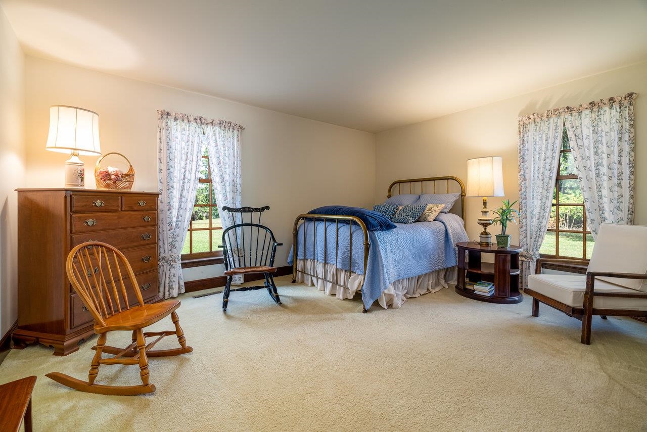 223 Fadley Road Weyers Cave, VA 24486 - Photo 36 of 59 a bedroom with furniture and a fireplace