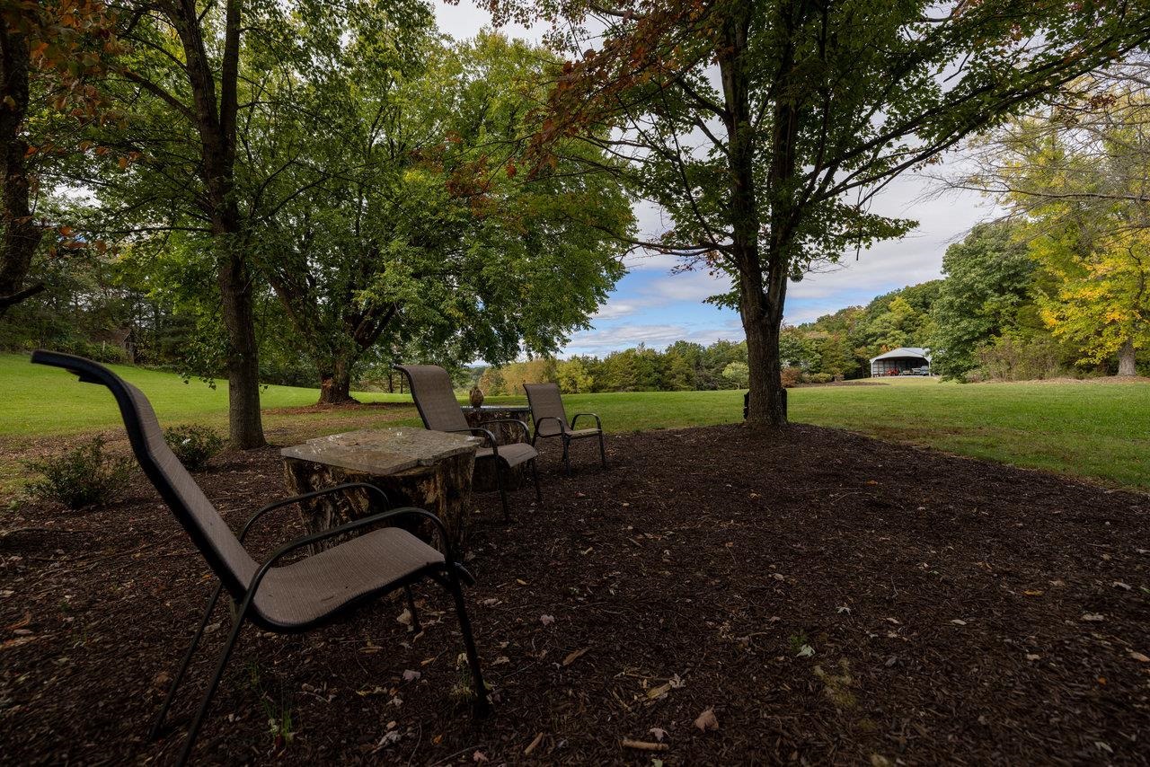 223 Fadley Road Weyers Cave, VA 24486 - Photo 9 of 59 a view of a backyard with table and chairs and a slide