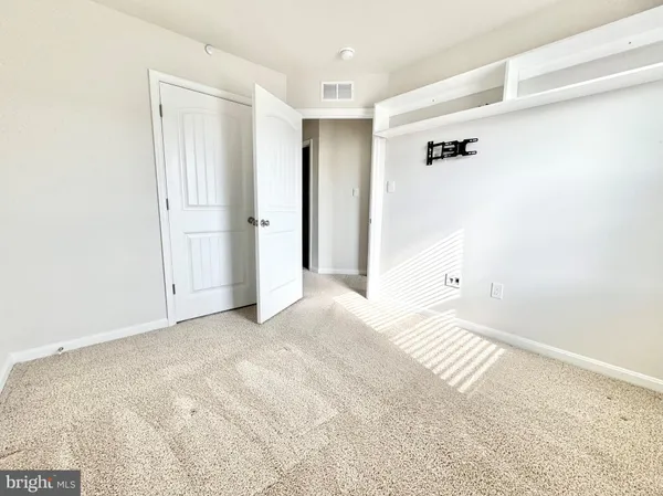 a view of a room with a white walls