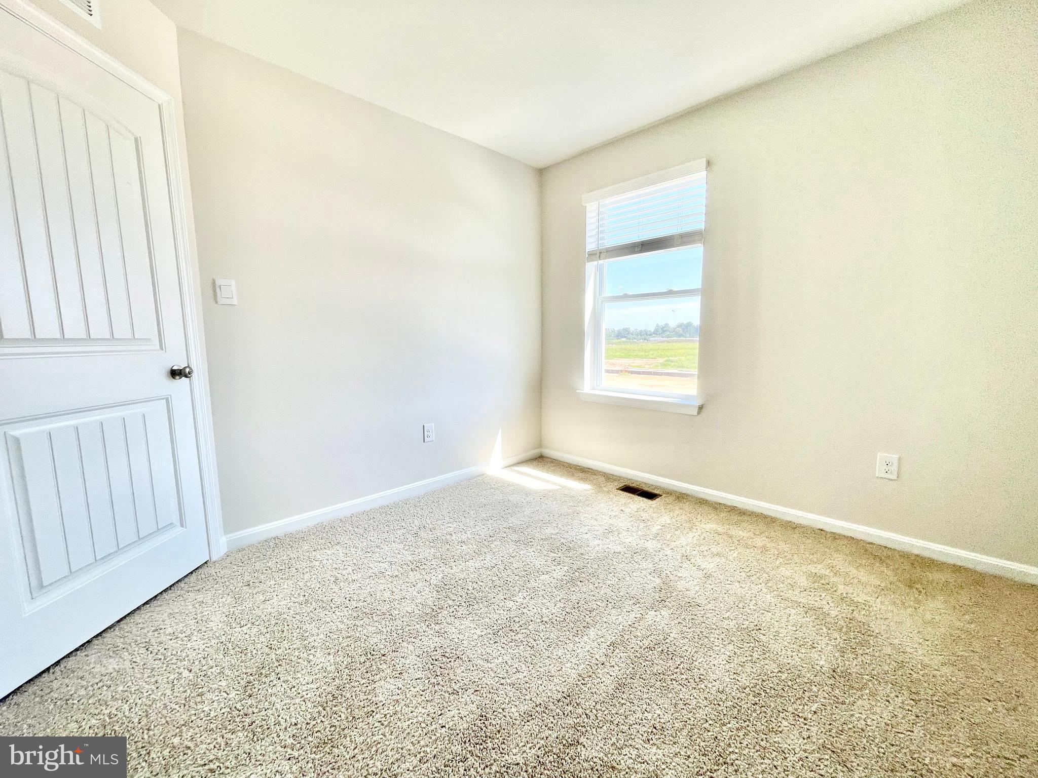 516 Ridgley Boulevard Dover, DE 19904 - Photo 14 of 18 an empty room with wooden floor and windows