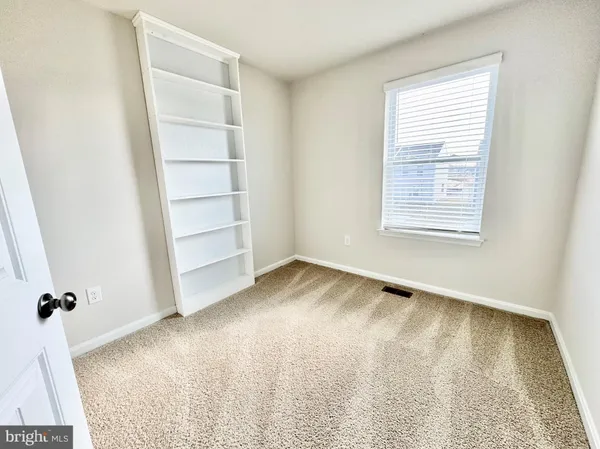 an empty room with a empty space and a window
