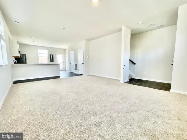 a view of a kitchen with a sink and a refrigerator