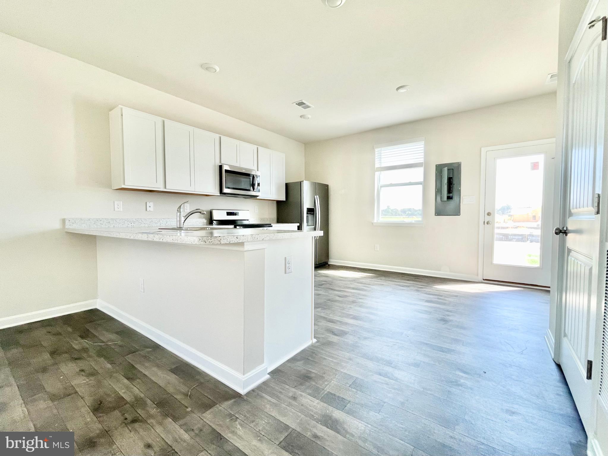 516 Ridgley Boulevard Dover, DE 19904 - Photo 6 of 18 a kitchen with stainless steel appliances granite countertop a stove a sink and a refrigerator