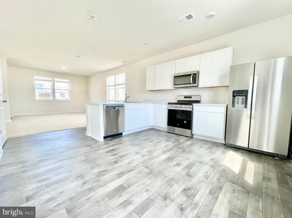 a kitchen with granite countertop a refrigerator and a stove
