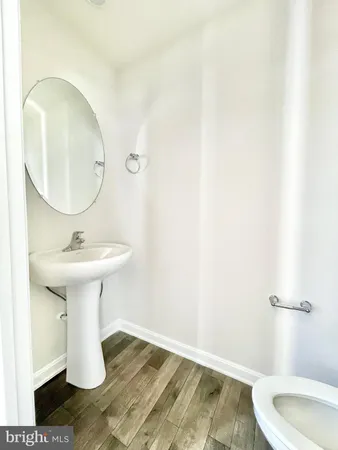 a bathroom with a sink toilet and a mirror