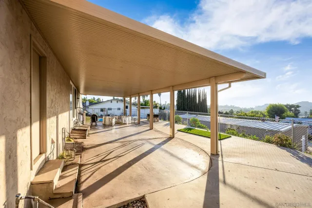 a view of a patio with a table and chairs