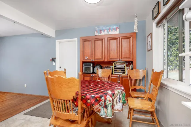 a dining room with furniture and wooden floor
