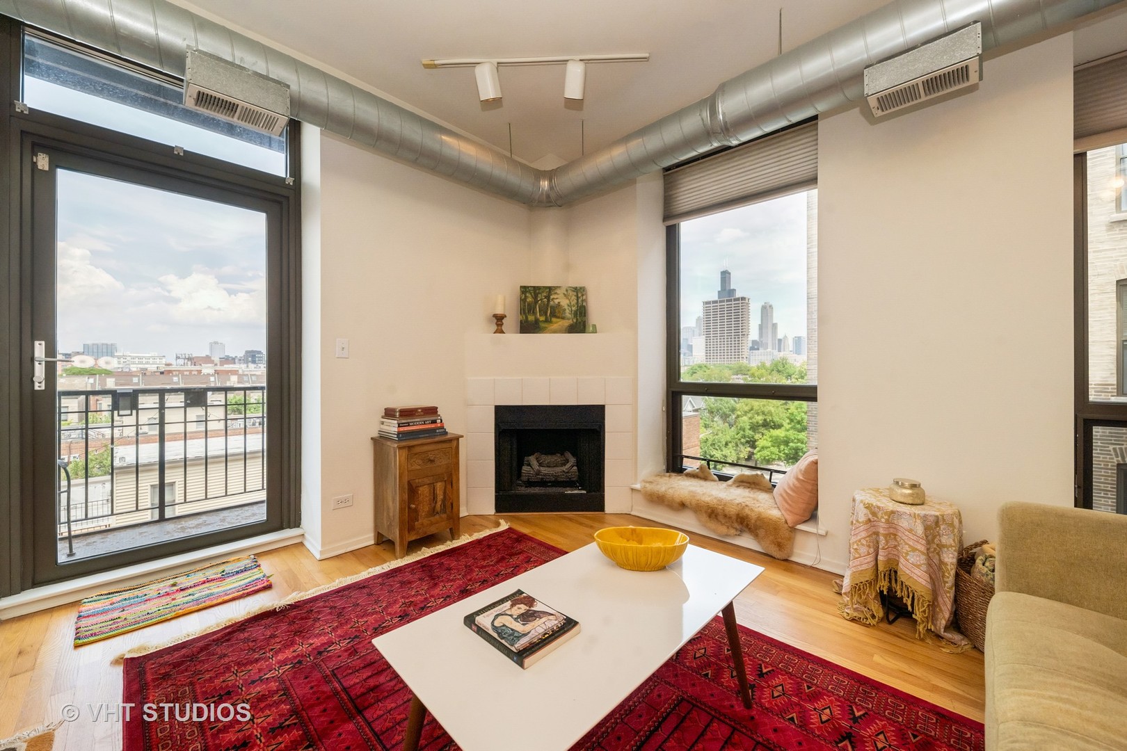 811 South Lytle Street, Unit 412 Chicago, IL 60607 - Photo 2 of 18 a living room with furniture a window and a fireplace