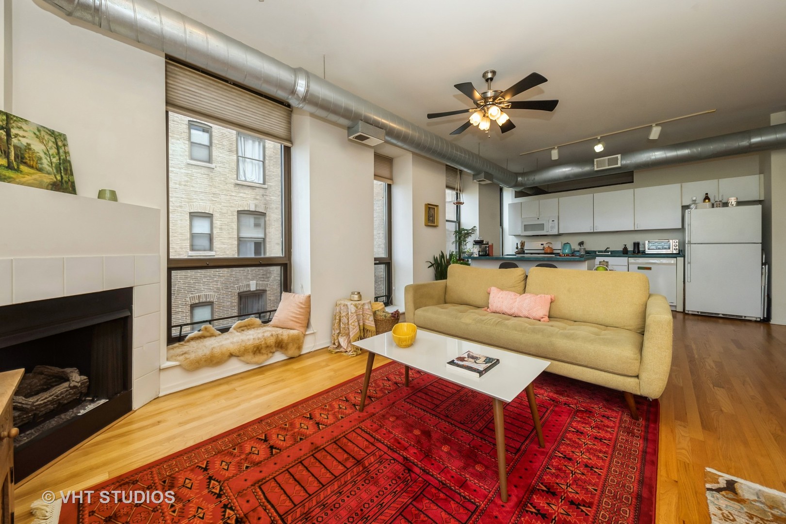 811 South Lytle Street, Unit 412 Chicago, IL 60607 - Photo 3 of 18 a living room with a couch and a fireplace
