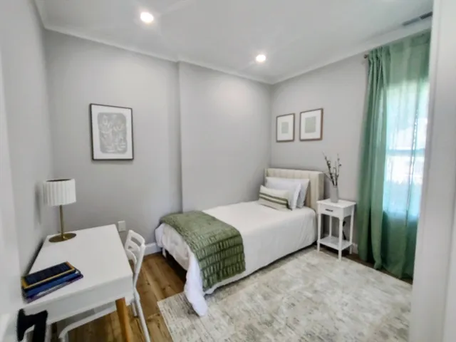 a bedroom with a bed and a desk