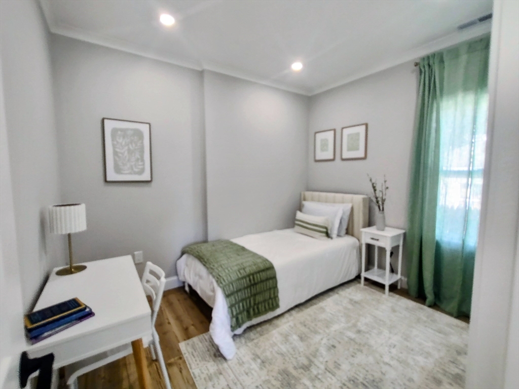 93 Grove Street, Unit 1R Fall River, MA 02720 - Photo 12 of 21 a bedroom with a bed and a desk