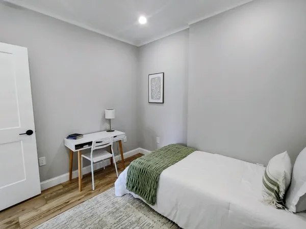 a bedroom with a bed and a chair